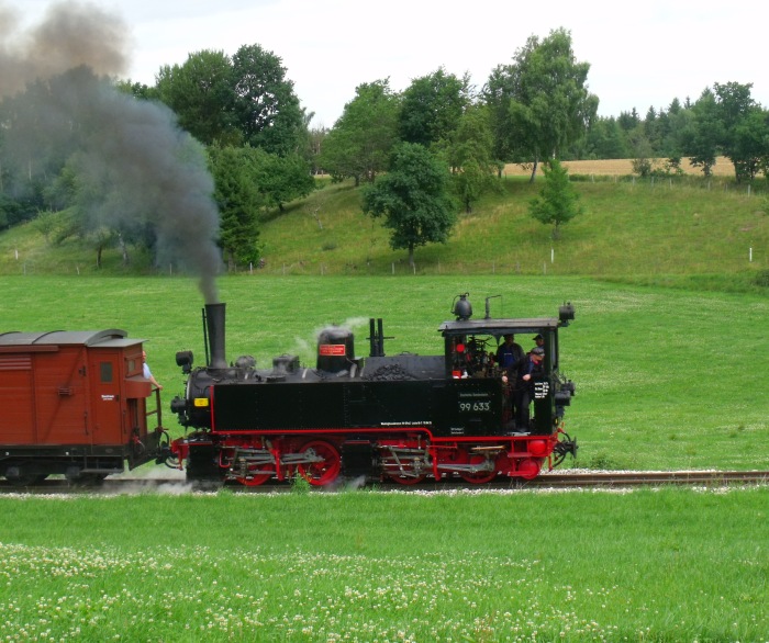 99 633 (Tv) mit dem ersten Zug des Tages nach Ochsenhausen in der Steigung bei Wennedach, um 11:18h am 09.07.2017
