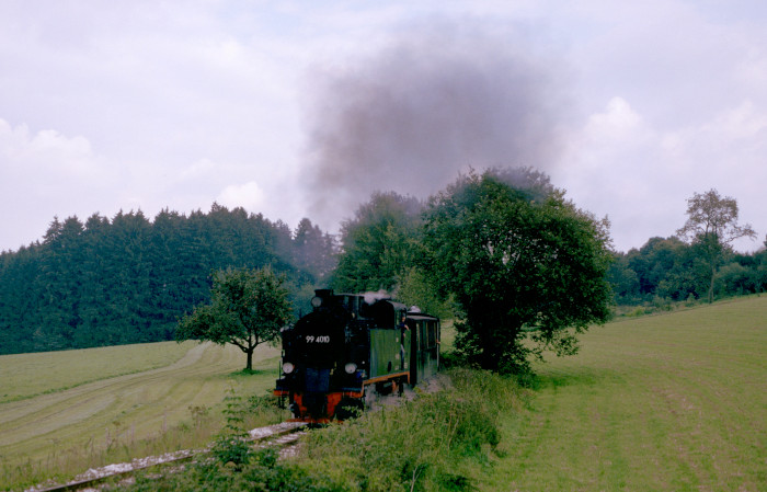 Lok Nr.10 als „99 4010“ mit Regelzug auf der schwäbischen „Öchsle“-Bahn von Ochsenhausen kommend Richtung Warthausen ziemlich schnell und lautstark in der Steigung hinter Reinstetten einige hundert Meter vor dem Scheitelpunkt der Bahn, fotografiert und aufgenommen am 22.09.1996 um 14:20h